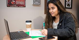 girl writing on a computer